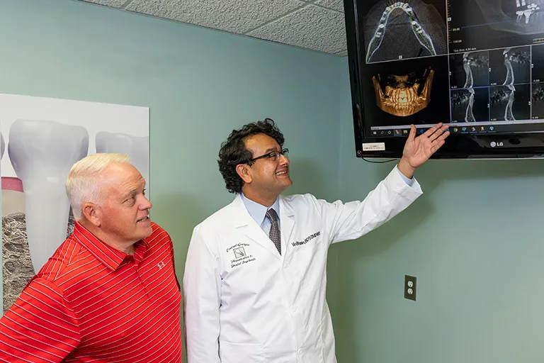 Image of Dr. Bhasin in a consultation with a patient.