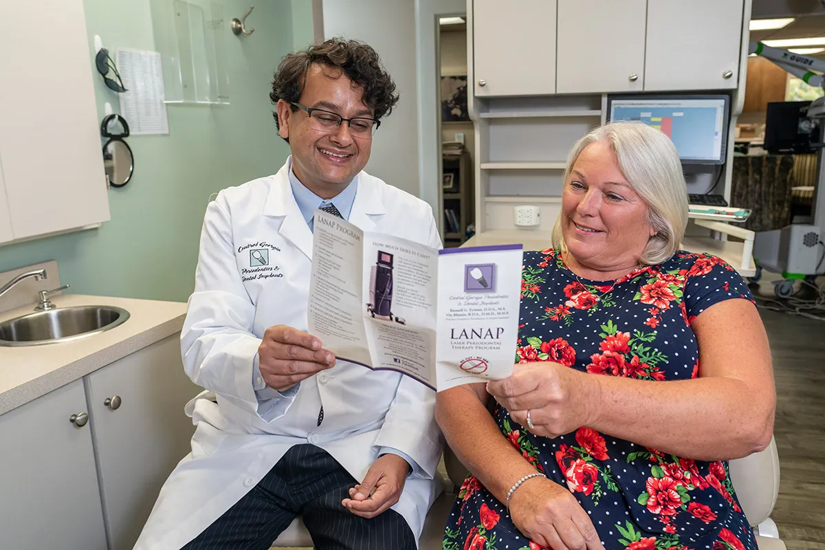 Image of Dr. Bhasin in a consultation with a patient.